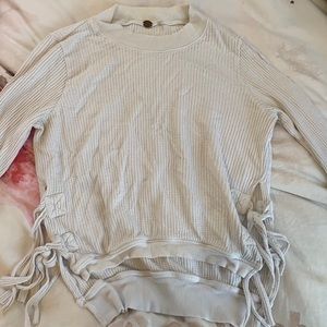 Waffle knit white free people sweater with cut outs on the side and ties!